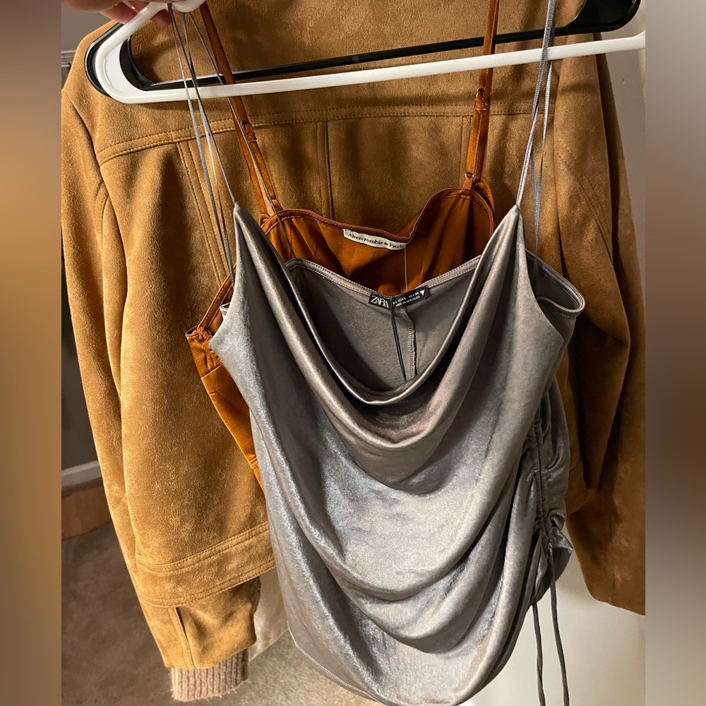 Silky silver spaghetti strap top. Perfect for a night out!